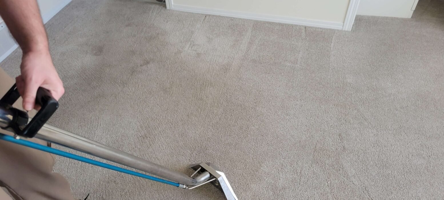Person using a wand carpet cleaning in Calgary Alberta