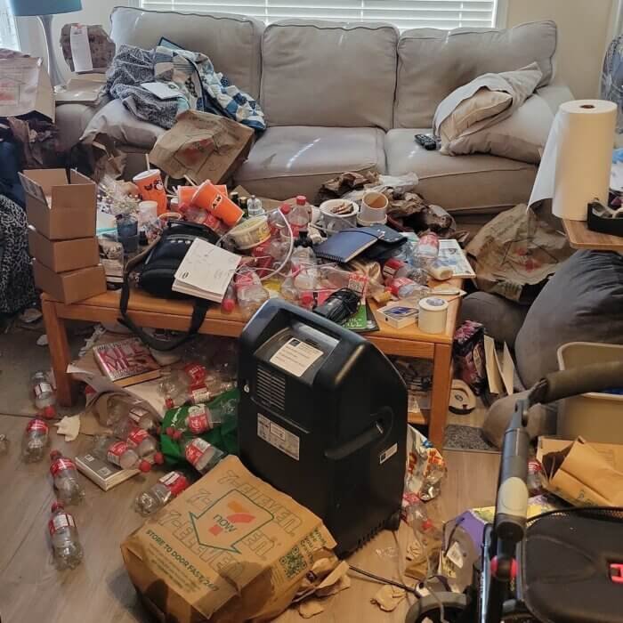 Living room filled with garbage, food containers, and bug infestation before professional biohazard, hording clean out and deep cleaning by Filthy Masters