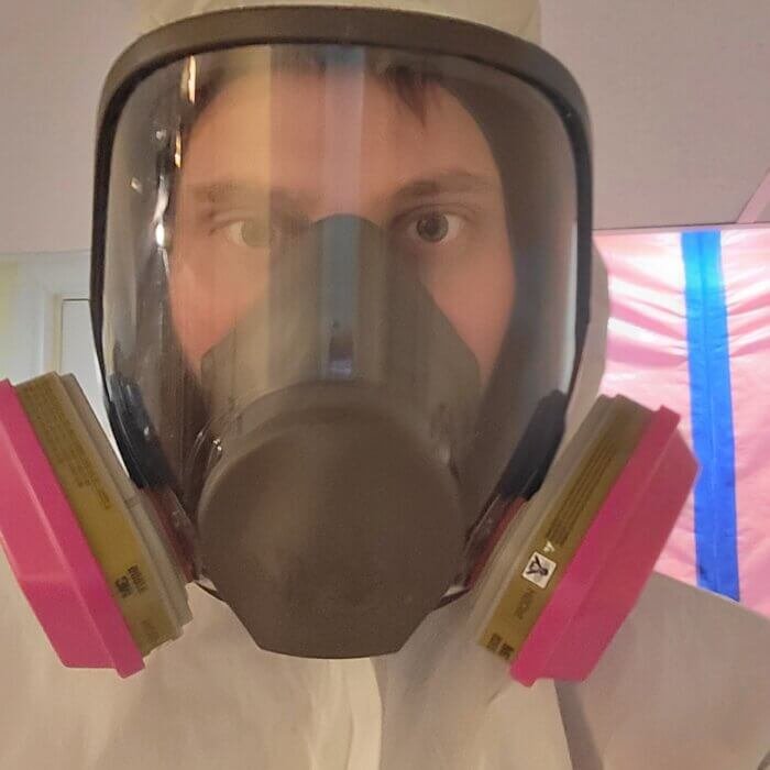 Christopher Rozenberg masked up with PPE suit on ready for a decontamination